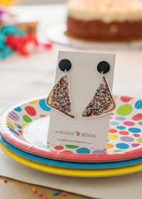 Acrylic fairy bread earrings shaped like sprinkle-covered bread triangles on a Kaboodle Designs card