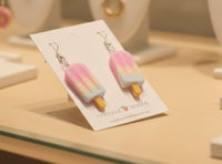 Angled close-up of popsicle earrings on card showing colour gradient and stick detail