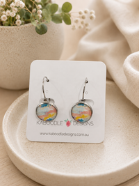 Round sorbet watercolour leverback earrings on a Kaboodle Designs card, showing pastel pink, blue and yellow abstract pattern