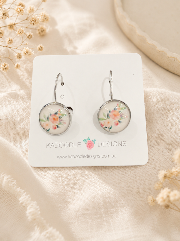 Round leverback dangle earrings with watercolour floral design on white display card