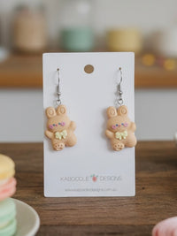 Caramel resin bunny drop earrings with bow detail on Kaboodle Designs card