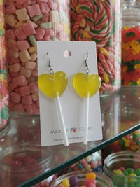 Yellow heart lollipop resin drop earrings on white stick, shown on Kaboodle Designs card