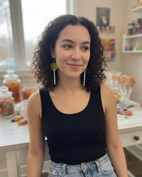 Model wearing yellow lollipop drop earrings, side view close-up