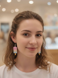 Close-up of model wearing pastel popsicle drop earrings, front-facing view
