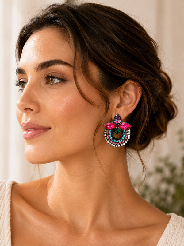 Close-up of model wearing rhinestone statement earring, side view showing teardrop and floral crystal detail