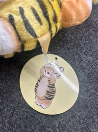 Mofusand tiger cat plush keychain viewed from behind with product tag attached