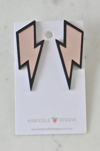 Pair of rose pink mirror lightning bolt stud earrings with black outline on card