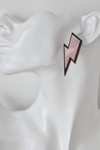 Single lightning bolt stud earring worn on ear for scale