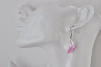 Close-up of teacup earring worn on a display ear model, side view