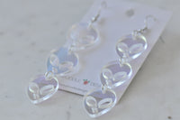Angled view of alien earrings from above showing clear acrylic and cut-out eye detail