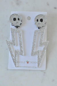 Silver glitter skull stud earrings with lightning bolt drops on Kaboodle Designs card