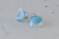 Pair of jellyfish earrings lying flat showing dome and tentacle detail
