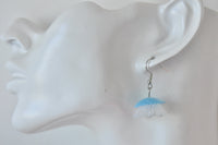 Close-up of jellyfish earring worn on a model ear, side view