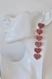 Red glitter heart drop earring shown on a display head for scale and length