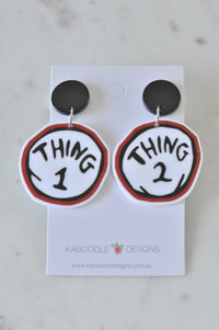 Thing 1 and Thing 2 acrylic dangle earrings with black stud tops on Kaboodle Designs card