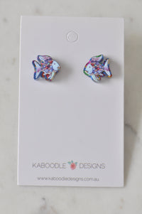 Pair of rainbow fish stud earrings with holographic scales on a Kaboodle Designs card