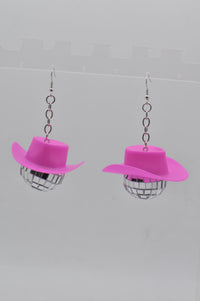 Front view of two disco ball cowboy hat earrings hanging on display hook