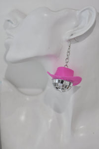 Close-up of disco ball cowboy hat earring worn on ear, side view