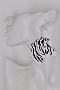 Close-up side view of laser cut zebra earring worn on a mannequin ear