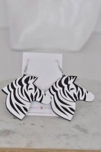 Pair of black and white zebra head drop earrings on jewellery card with stainless steel hooks