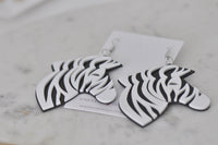 Zebra drop earrings lying flat showing layered perspex edge and stripe detail