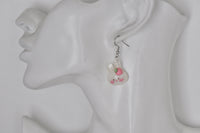 Single bunny strawberry earring shown on ear for scale