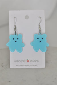Pair of blue resin teddy bear drop earrings on a Kaboodle Designs card
