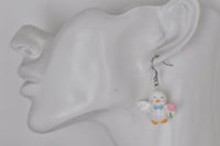 Duck drop earring shown worn on ear for scale