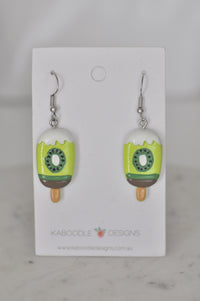 Pair of kiwifruit popsicle resin earrings on Kaboodle Designs card, front view