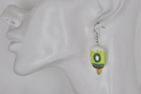 Kiwifruit popsicle earring shown on ear for scale