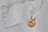 Honey jar earring shown worn on ear for scale