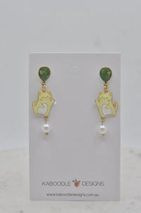 Gold-tone earrings on card showing a cream cat charm floating from a green balloon with a pearl drop