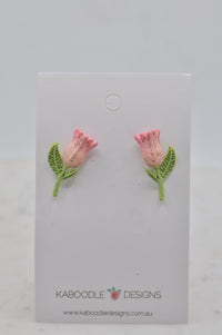 Pair of pink tulip stud earrings with green leaves on a Kaboodle Designs card