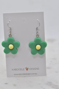 Green resin flower drop earrings with yellow centres on Kaboodle Designs card, front view