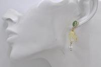 Balloon cat earring shown worn on a model's ear, side profile view