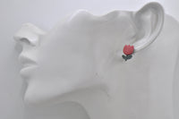 Red tulip stud earring shown worn on a model's ear