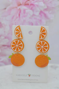 Orange fruit drop earrings on card showing wedge, slice and whole orange tiers
