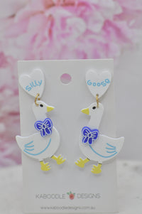 Pair of white perspex goose drop earrings on card, reading Silly and Goose