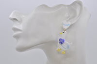 Silly Goose earring worn on ceramic ear model, side view