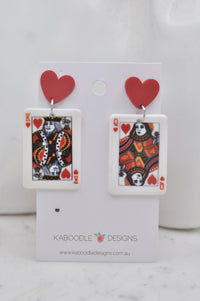 Acrylic King and Queen of Hearts card earrings on a heart-shaped stud, displayed on card backing