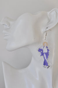 Close-up of purple tracksuit earring worn on a model ear, showing clear acrylic edge