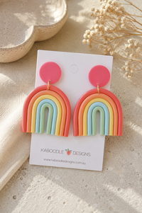 Pink clay stud rainbow drop earrings in coral, orange, yellow, blue and mint on Kaboodle card