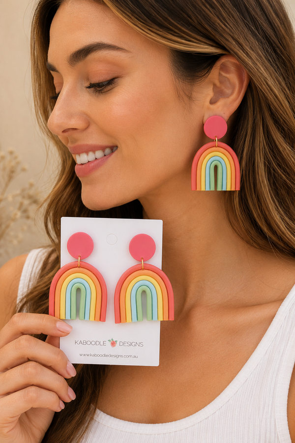 Model wearing pink clay rainbow drop earring, close-up side view