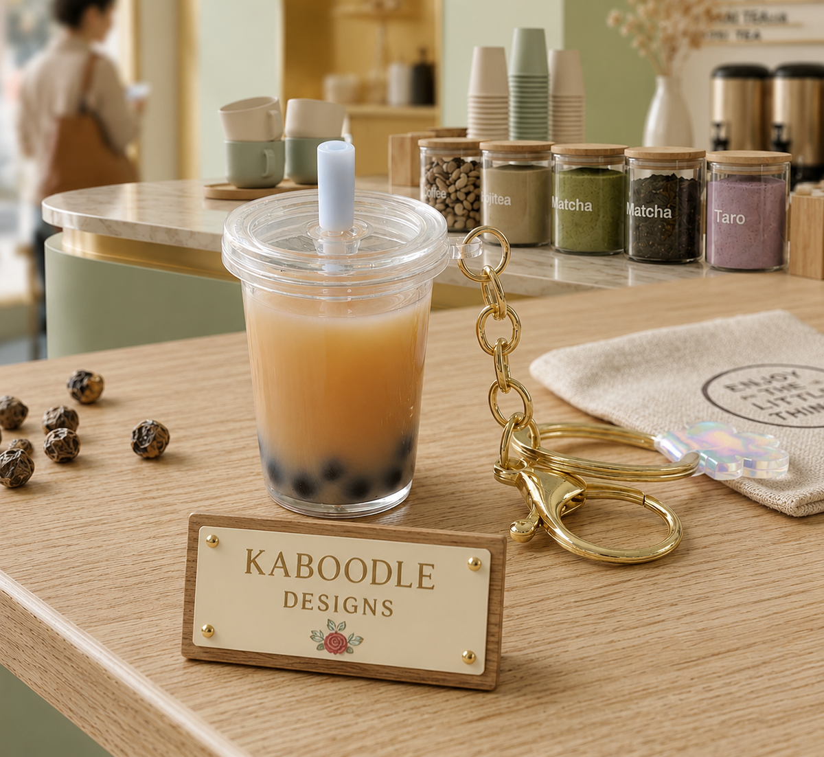 Perspex milk tea keychain with real liquid, fake pearls and ice, gold keyring chain, cafe counter backdrop