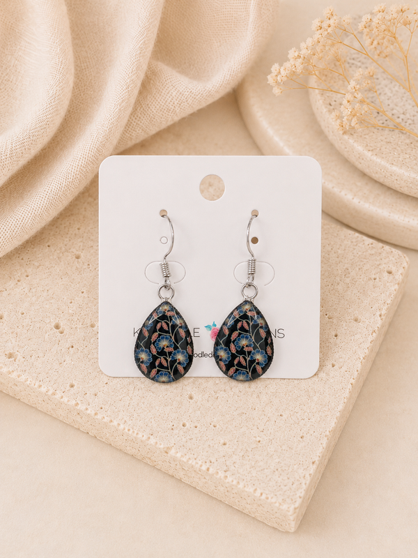 Teardrop dangle earrings on card with navy blue floral print and stainless steel hooks
