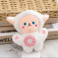 White fluffy plush sheep keychain with pink cheeks, blue eyes and embroidered flower detail, front view