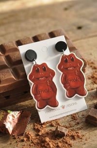 Close-up of Freddo chocolate frog earrings showing glossy brown printed detail