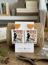 Rectangular acrylic drop earrings with mustard half-moon tops and cat lady cartoon print, shown on card