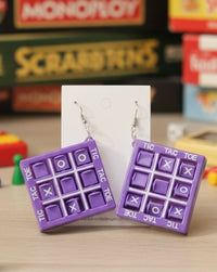 Purple tic tac toe drop earrings on card, front view showing X and O grid detail