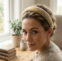 Woman wearing the boucle headband over an updo, close-up front view